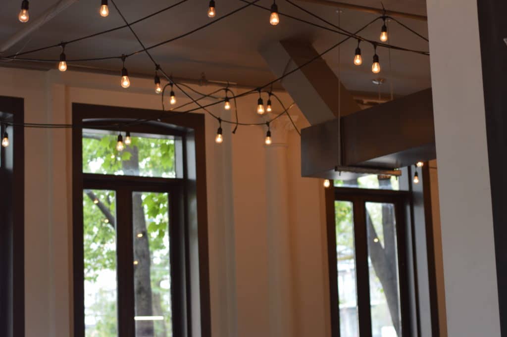 Sunday services take place at 25 Liberty and create warmth with globe string lights and many smiles. Photo taken by Meg Marshall.