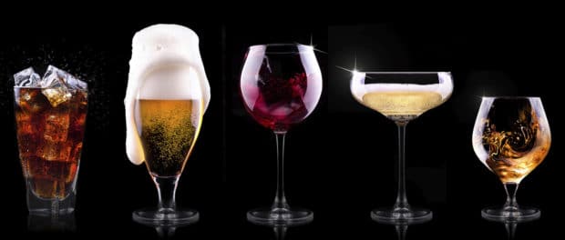 set with different drinks on black background