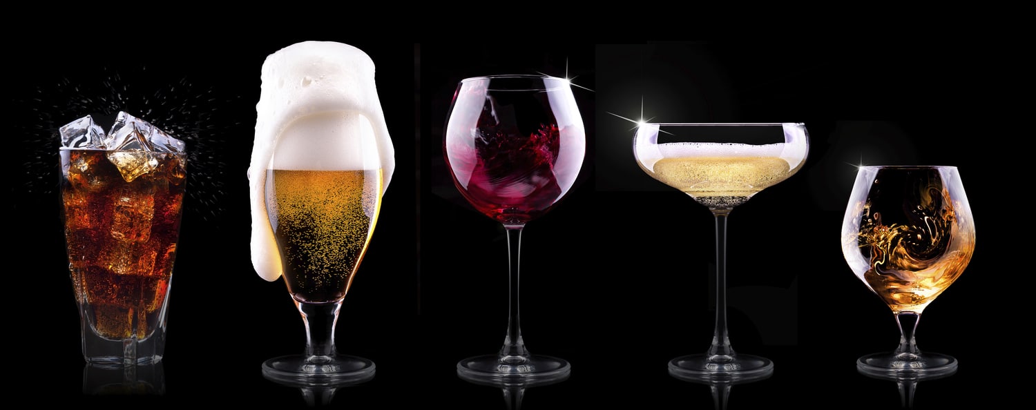 set with different drinks on black background